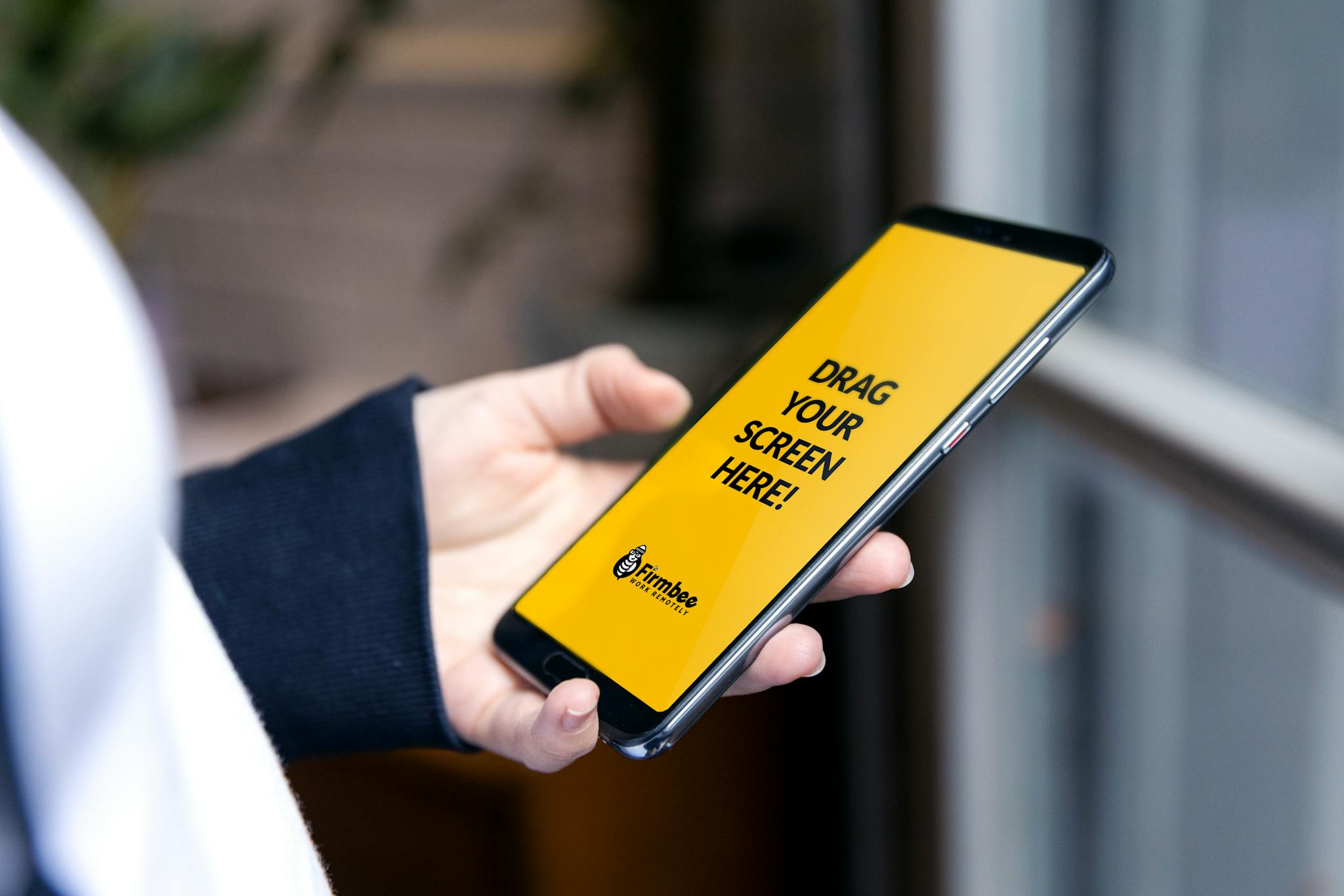 Close-up of a person holding a smartphone with a customizable screen, perfect for app demos.